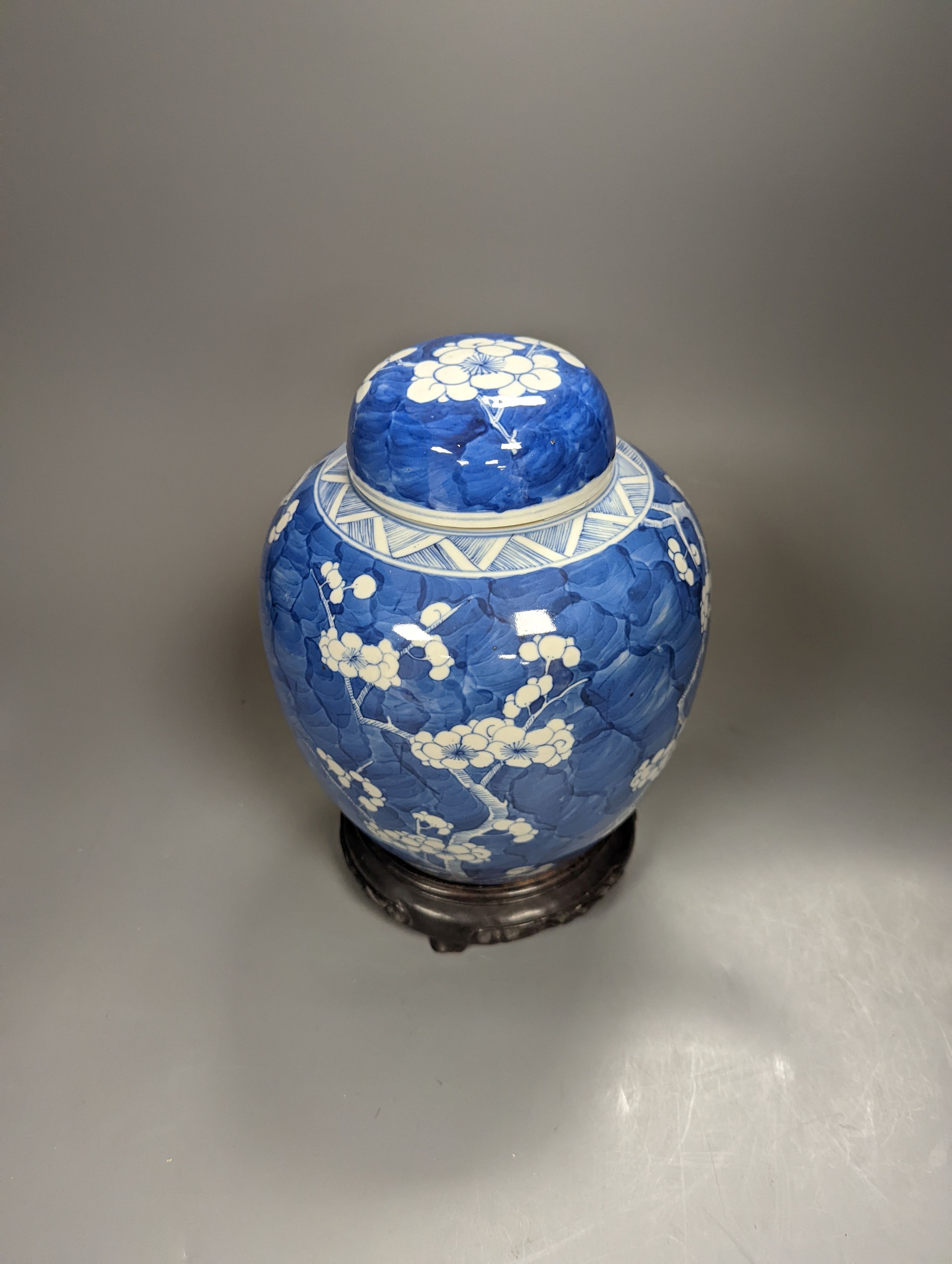 A 19th century Chinese prunus blossom ginger jar and cover, on stand, height 25cm